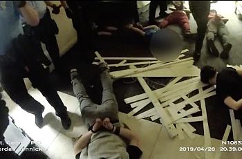 This screenshot of body camera footage shows police handcuffing teenage boys during a riot at Red Rock Canyon School on April 28