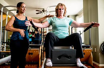 Julie Swann-Paez, a survivor of the San Bernardino shooting, works with a Pilates instructor to strengthen muscles during her re