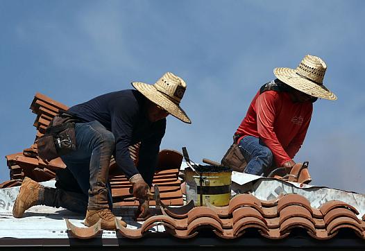Workers on a roof in hot temps.