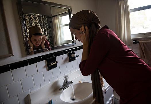 Person standing in front of a bathroom mirror