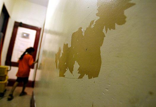 A wall and a person walking against it