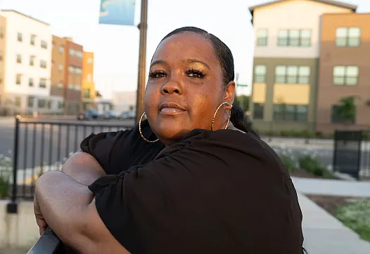 Person in black top standing on a railing
