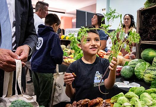 A person buying vegetables at a fruit mongers'