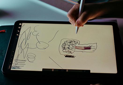 A child draws on a sketch pad.