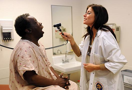 A nurse practitioner sees a patient.