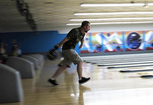 Ben Lingle aims a bowling ball in Redding, California. He and his family had to evacuate their home due to the Carr Fire last ye