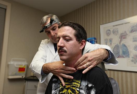 Raymond McElfers has his throat examined by his doctor. (Photo by Emily Maxwell | WCPO)