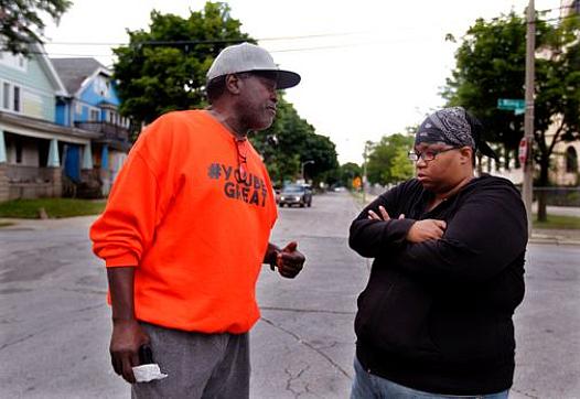 Andre Lee Ellis, left, talks with Lisa Huston, right, who escorted her son to the "We Got This" summer program. Ellis was thanki