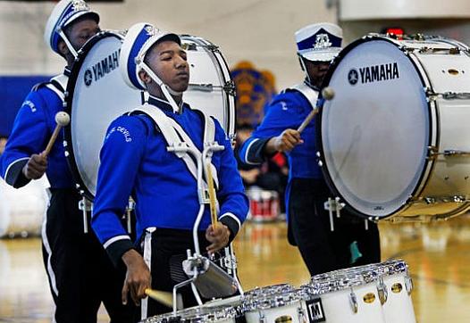 Maleak Taylor (left), a freshman at North Divison High School, plays quints for the drumline.