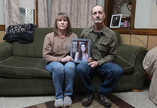 Kay and Jon Steigerwalt sit in the living room of her Palmerton home, holding a photograph of their daughter Deanna. Deanna died