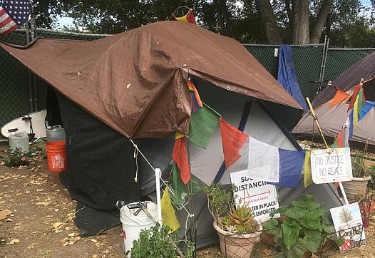 RESIDENTS OF A NEW MANAGED HOMELESS CAMP AT SAN LORENZO PARK HAVE ADDED THE TRAPPINGS OF HOME TO THEIR TENTS.